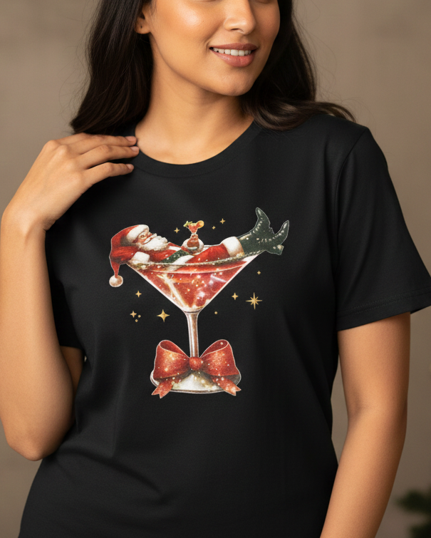 Woman wearing a black t-shirt with a Christmas-themed design in front of a decorated tree