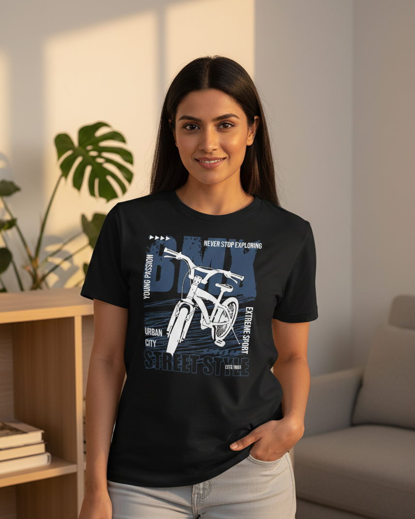 Woman wearing a black t-shirt with a bicycle graphic and text in a living room.