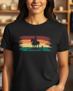 Woman wearing a black t-shirt with a colorful graphic of a horse and rider in a store setting