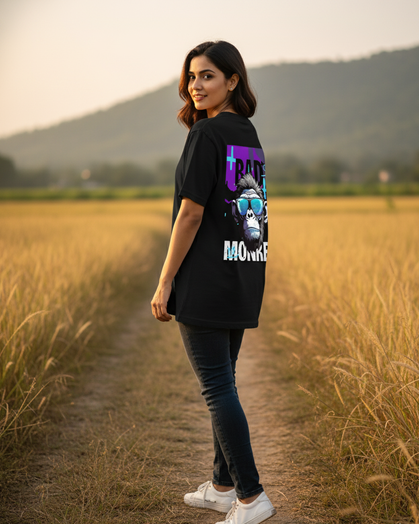 Woman wearing a black t-shirt with a graphic design in a field