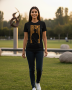Woman wearing a black t-shirt with a graphic design in a park