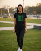Woman wearing a black t-shirt with a green logo on a grassy field