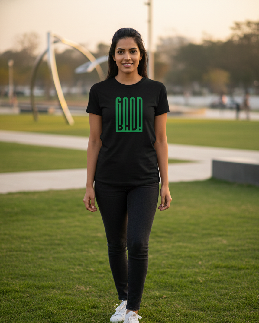 Woman wearing a black t-shirt with a green logo on a grassy field