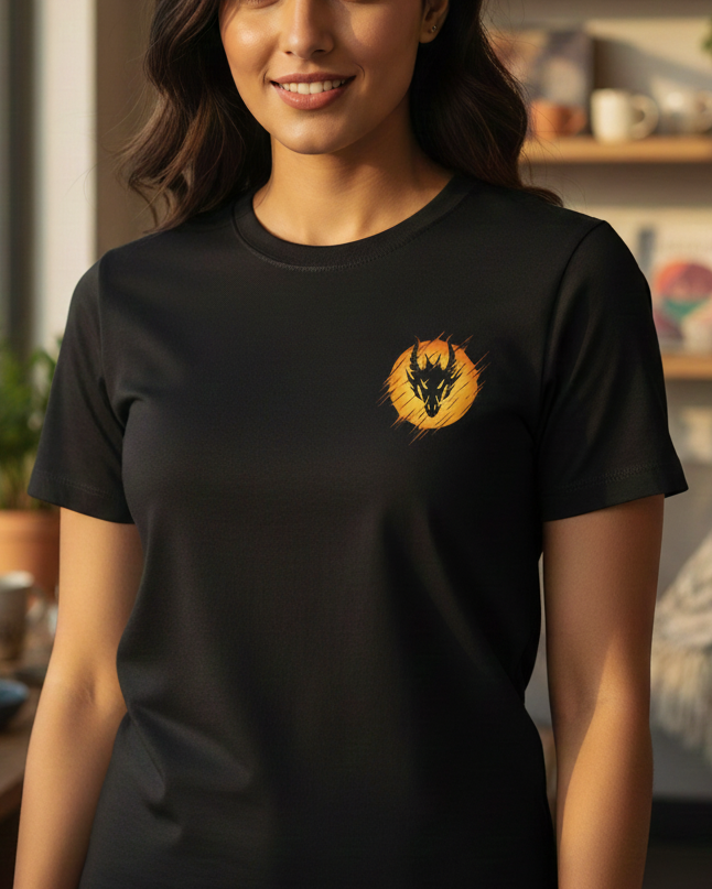 Woman wearing a black t-shirt with a logo in a room with plants and shelves.
