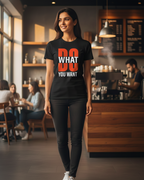 Woman wearing a black t-shirt with a motivational quote in a coffee shop.