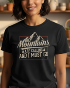 Woman wearing a black t-shirt with a mountain design and text in a home setting