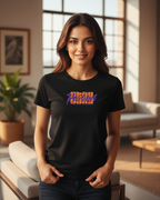 Woman wearing a black t-shirt with colorful text in a bright living room.