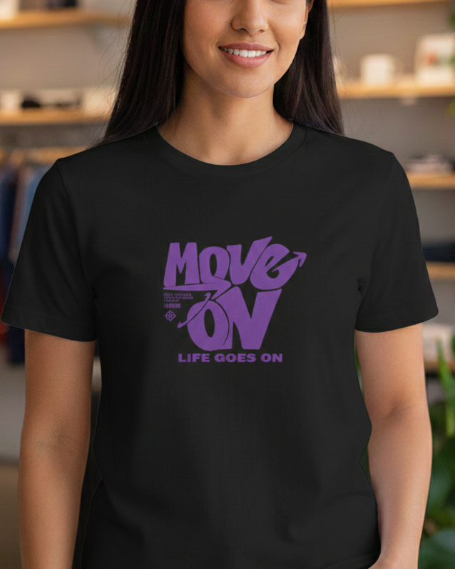 Woman wearing a black t-shirt with purple text in a clothing store