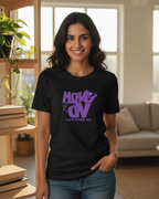 Woman wearing a black t-shirt with purple text in a living room setting