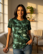 Woman wearing a green tie-dye shirt in a bright living room.