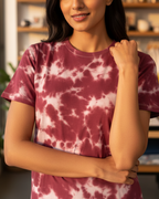 Woman wearing a tie-dye shirt in a home setting