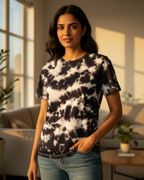 Woman wearing a tie-dye shirt in a living room setting