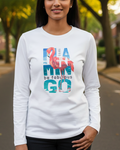 Woman wearing a white sweatshirt with colorful text in an outdoor setting