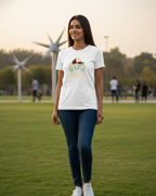 Woman wearing a white t-shirt with a graphic design on a grassy field