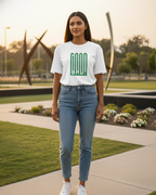 Woman wearing a white t-shirt with green text and blue jeans standing outdoors.