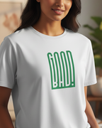 Woman wearing a white t-shirt with green text in a living room setting