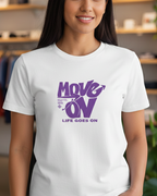 Woman wearing a white t-shirt with purple text in a clothing store