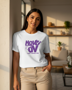 Woman wearing a white t-shirt with purple text in a living room setting