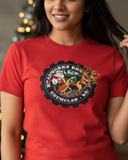 Women wearing a red t-shirt with a graphic design in a festive indoor setting.