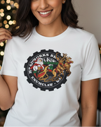 Women wearing a white t-shirt with a logo in front of a brick wall with Christmas decorations.