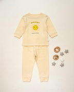 Yellow baby outfit with a sun design on a white background