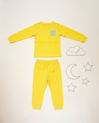 Yellow children's pajama set with cloud, moon, and star illustrations on a light background