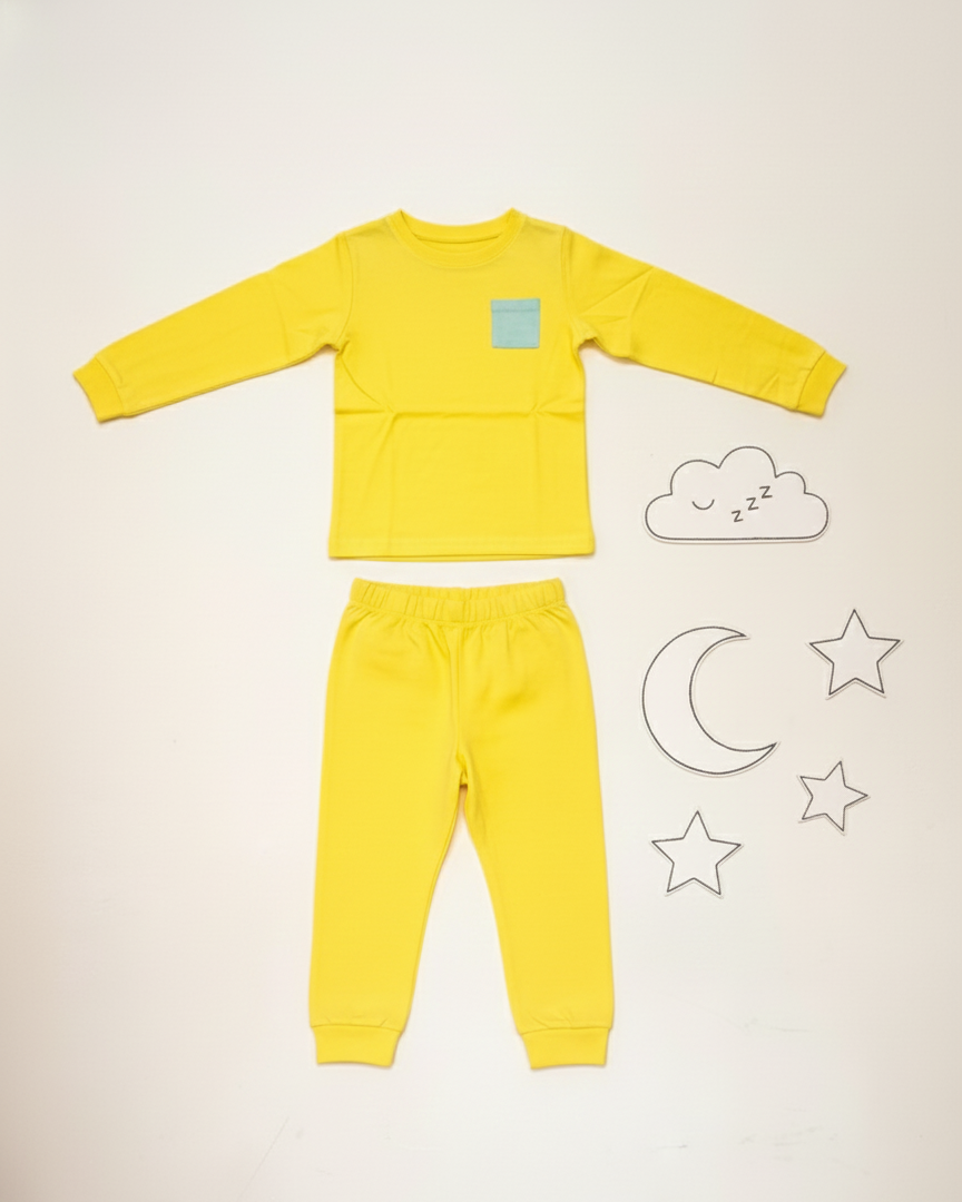 Yellow children's pajama set with cloud, moon, and star illustrations on a light background