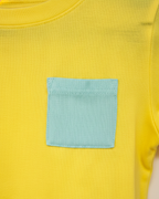 Yellow shirt with a square teal pocket