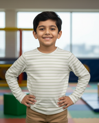 Young boy standing in a classroom with colorful equipment in the background