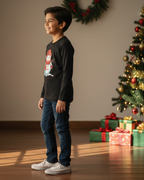 Young boy standing in a room with a Christmas tree and presents.