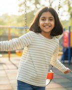 Young girl on a swing set in a playground