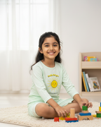 Young girl playing with colorful building blocks on a light-colored rug