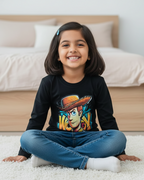 Young girl sitting on a carpeted floor wearing a black t-shirt with a colorful graphic design.