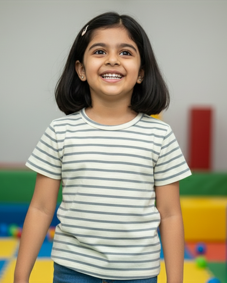 Young girl smiling in a colorful play area