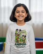 Young girl wearing a 'Disney Animal Kingdom' shirt in a colorful room.