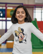 Young girl wearing a Minnie Mouse shirt in a colorful indoor playground.