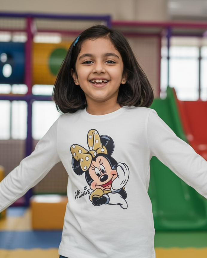 Young girl wearing a Minnie Mouse shirt in a colorful indoor playground.
