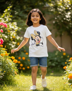 Young girl wearing a Minnie Mouse t-shirt in a garden