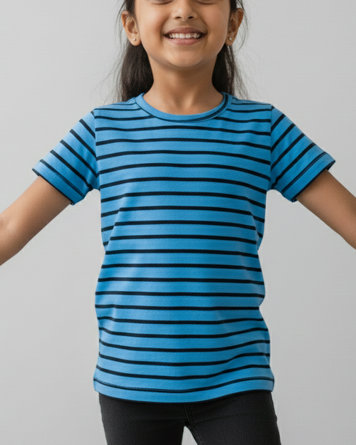 Young girl wearing a blue striped shirt against a gray background