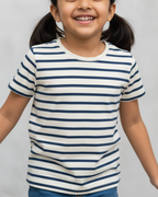 Young girl wearing a striped shirt against a plain background