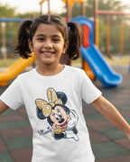 Young girl wearing a t-shirt with a cartoon character on a playground.