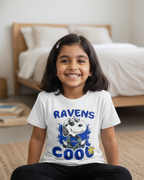 Young girl wearing a white t-shirt with 'RAVENS COOL' design sitting on the floor.