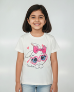 Young girl wearing a white t-shirt with a cartoon bunny design on a plain background