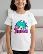 Young girl wearing a white t-shirt with a colorful dinosaur graphic and text in a bedroom setting.