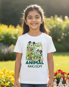 Young girl wearing a white t-shirt with cartoon characters and 'Animal Kingdom' text, standing in a garden.