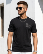 Young man wearing “Eat, Sleep, Travel, Repeat” embroidered Black Regular Fit T-shirt