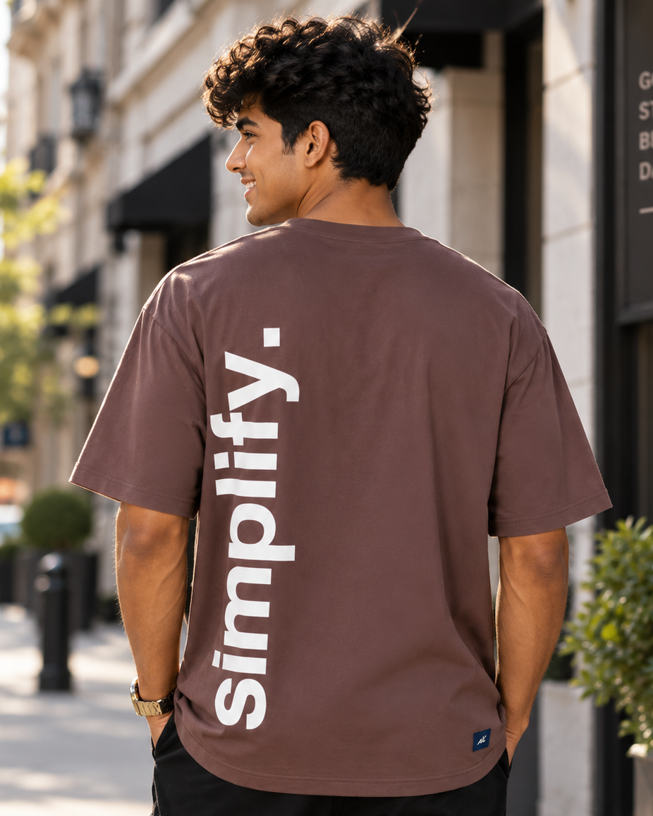 Young man wearing “Simplify” HD print Brown Oversized T-shirt which of back pose