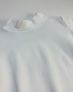 Zoomed White long-sleeve shirt with a ruffled collar on a plain background